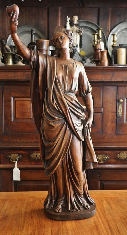 LARGE FINELY CARVED GEORGIAN FEMALE FIGURE BEARING A HEART