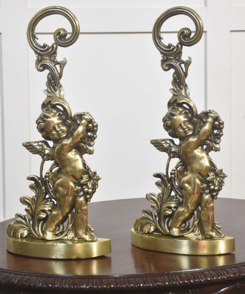 PAIR OF BRASS PUTTI DOOR STOPS
